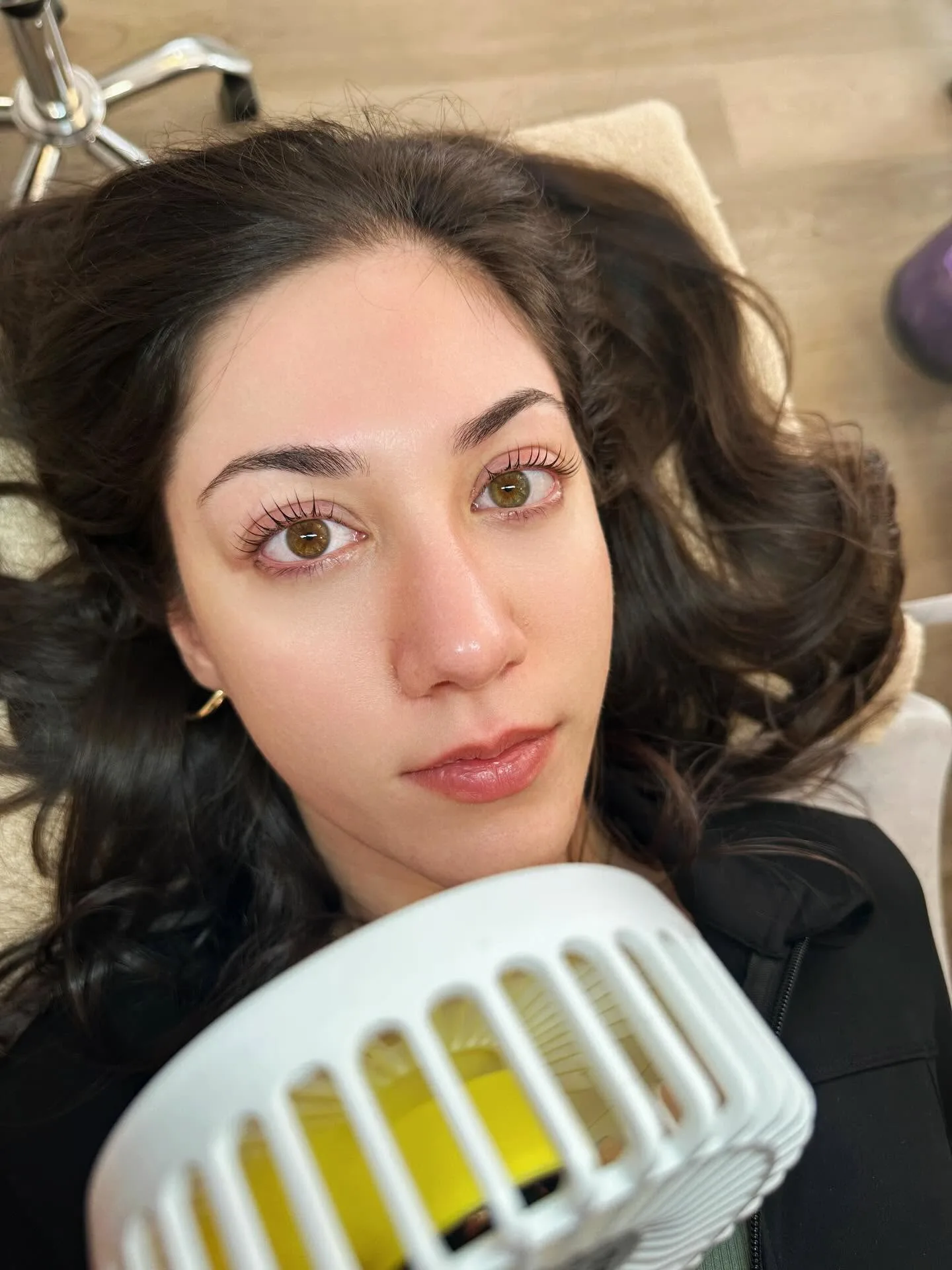 Client reclining with a fresh lash extension set