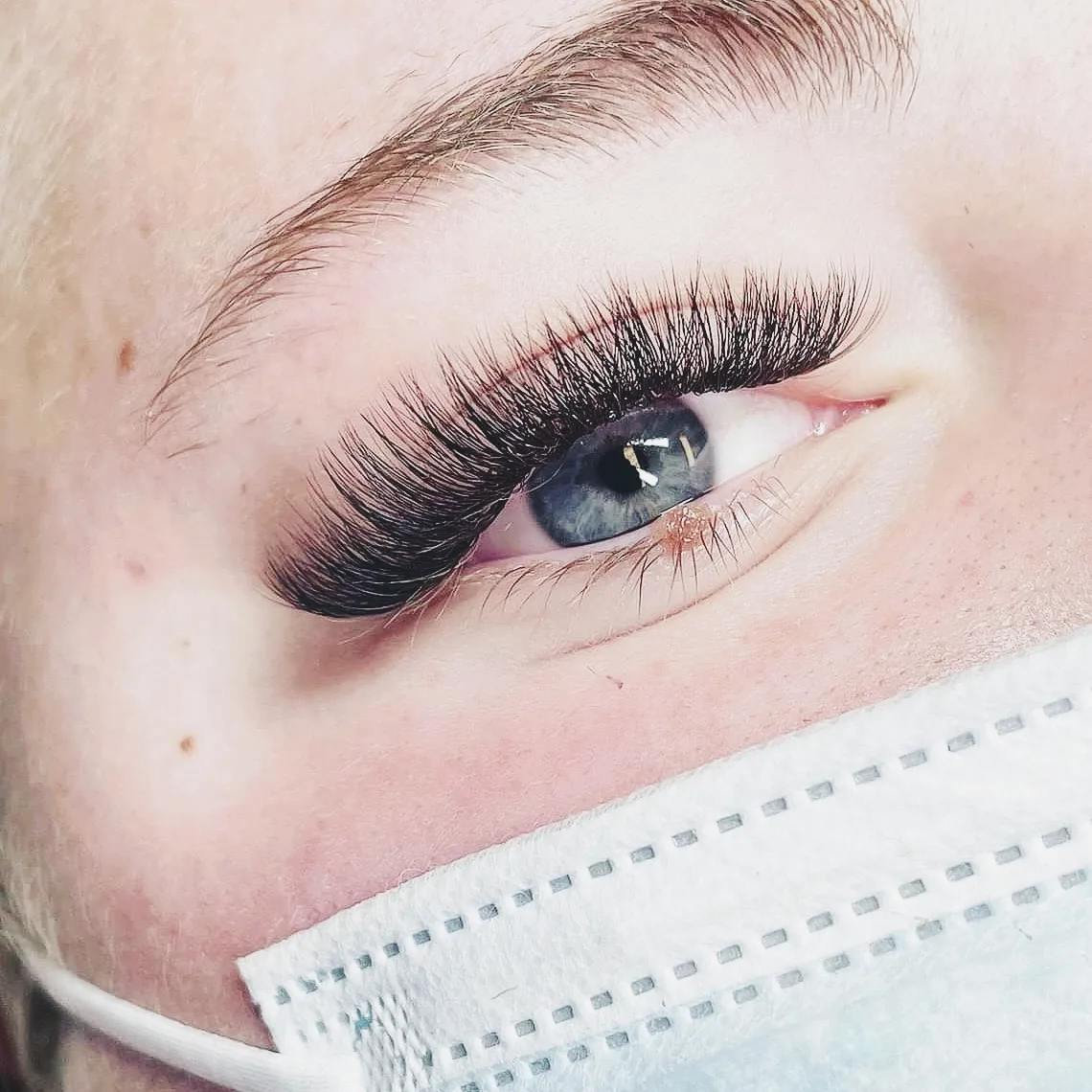 Macro — blue eye with lash extensions
