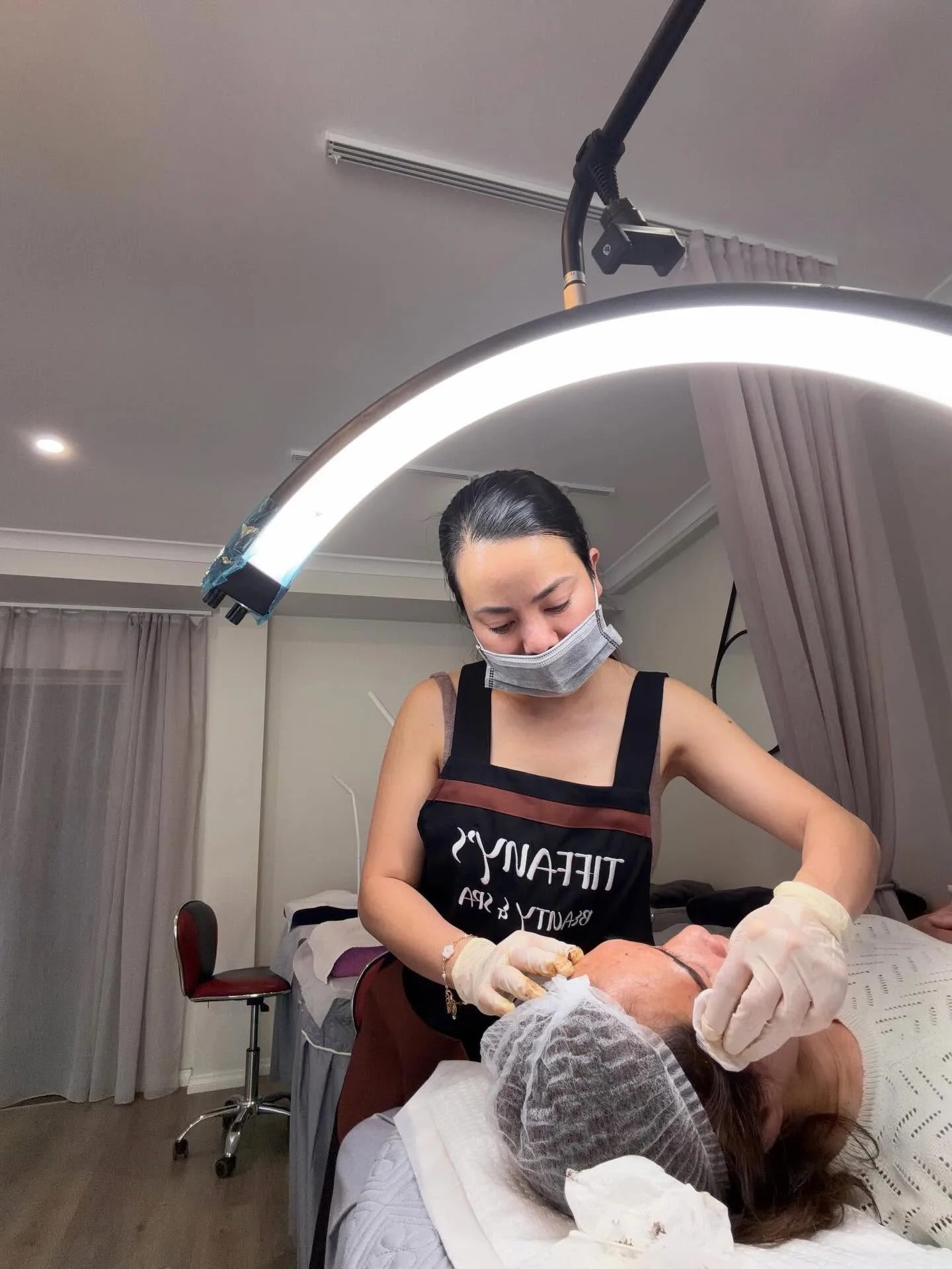 Facial treatment in progress under a ring light