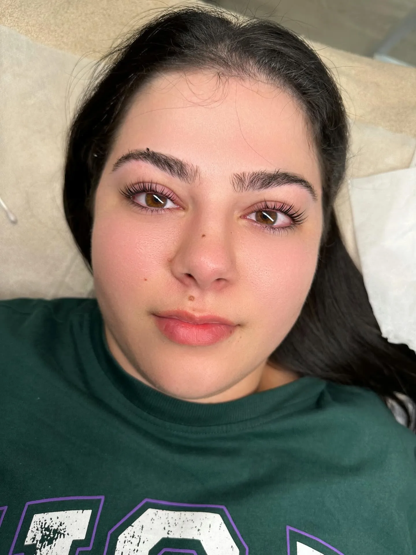 Close portrait showing natural makeup and subtle lash extensions
